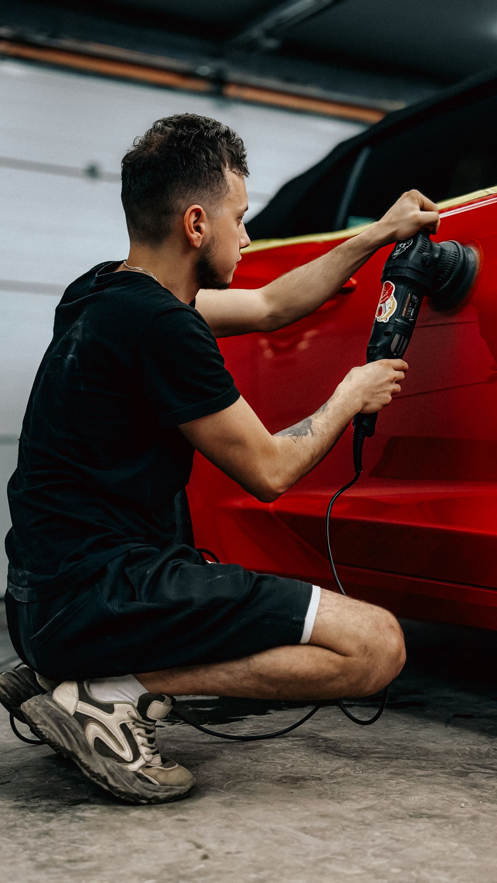 A vehicle panel being polished during detailing